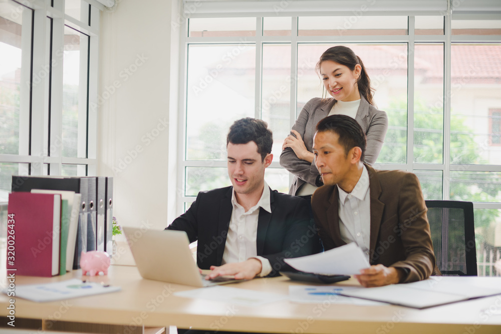 Businessmen are looking at the business plan and business results from the notebook in the office. Businessmen are looking at the business plan and business results from the notebook in the office.