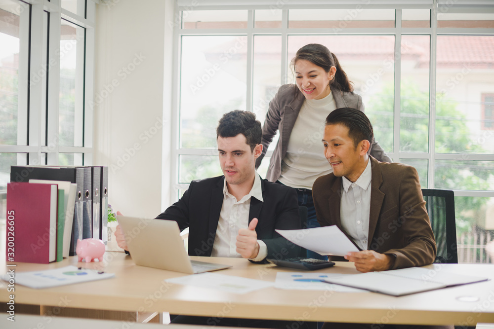 Businessmen are looking at the business plan and business results from the notebook in the office. Businessmen are looking at the business plan and business results from the notebook in the office.