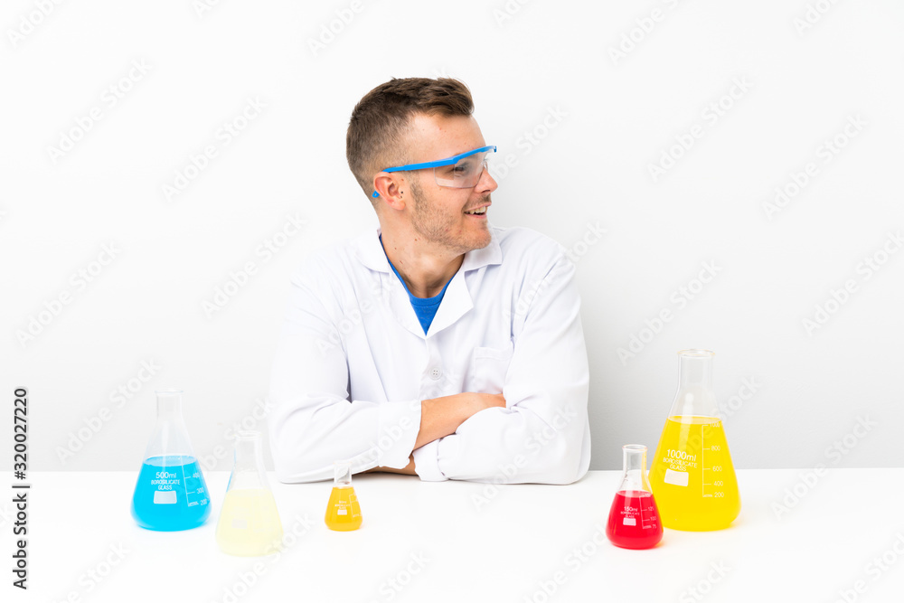 Young scientific with lots of laboratory flask laughing Young scientific with lots of laboratory flask laughing