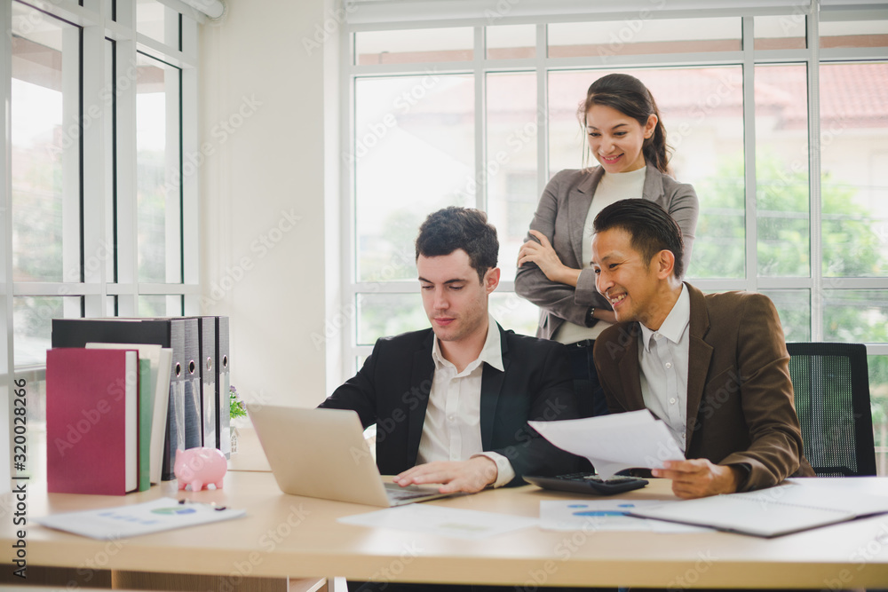 Businessmen are looking at the business plan and business results from the notebook in the office. Businessmen are looking at the business plan and business results from the notebook in the office.