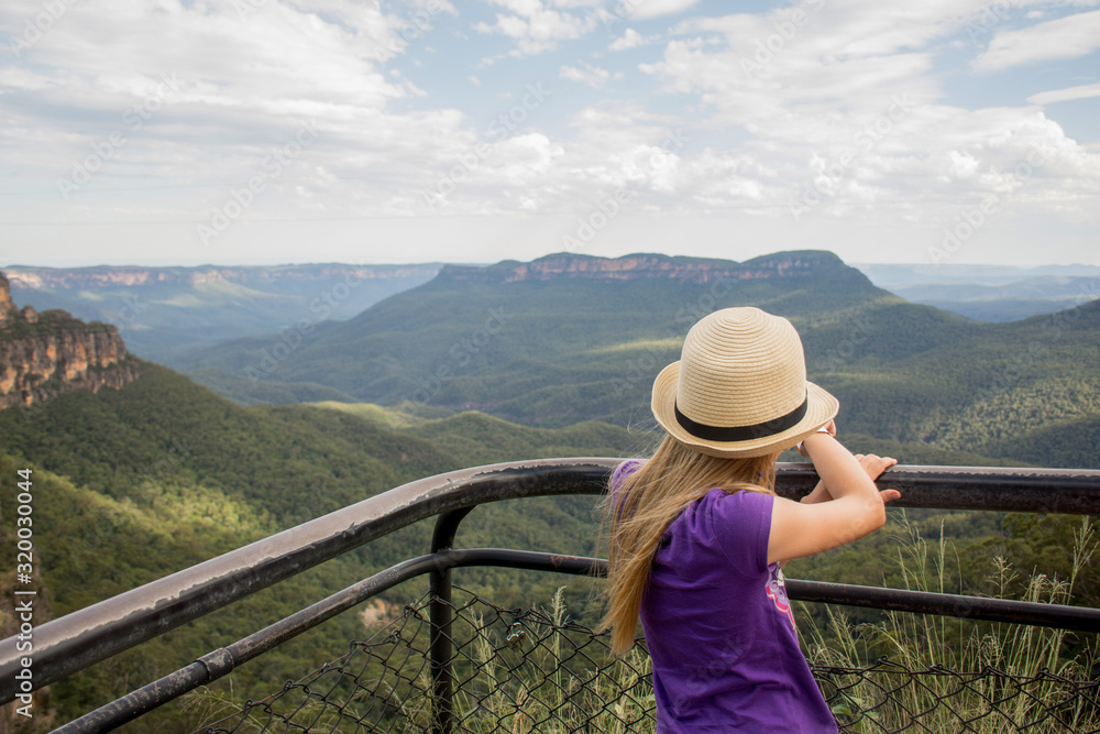 A girl wearing hat looking at the landscape of Blue Mountains and Jamison valley