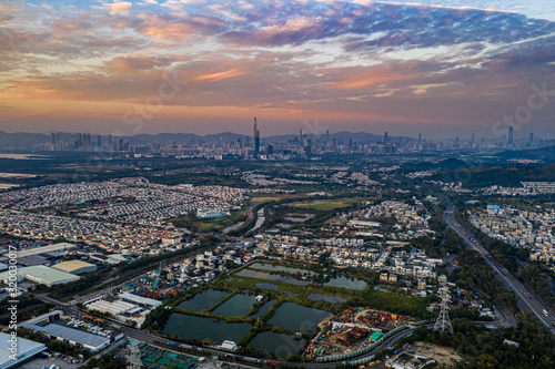 Aerial View of rural green fields in Hong Kong border and skylines in Shenzhen China
