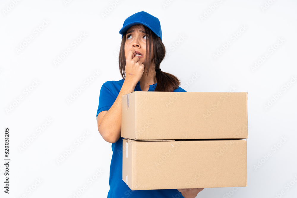 Young delivery brunette girl over isolated white background nervous and scared Young delivery brunette girl over isolated white background nervous and scared