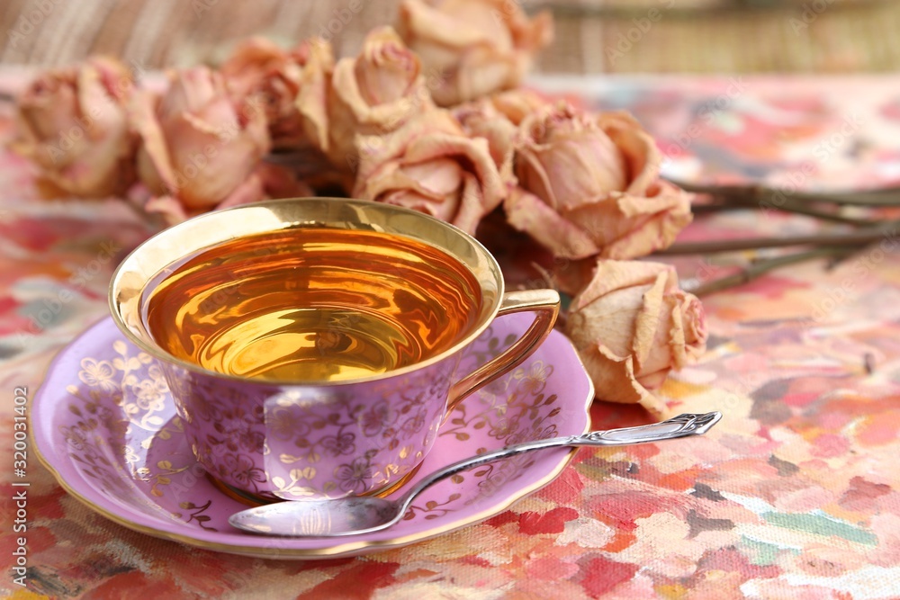 Silver spoon and pink cup with golden bottom on Valentine 's Day Silver spoon and pink cup with golden bottom on Valentine 's Day