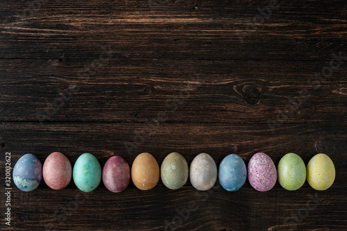 Different easter eggs on wooden background