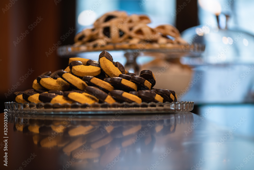 Biscuits with chocolate, on a wooden bar counter in Italy