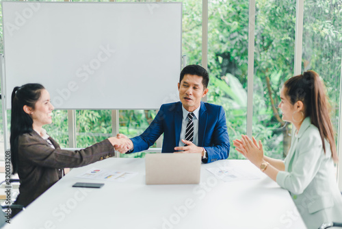 Managers and secretaries meeting and discussing business results from notebooks and paper charging statistics are in the company.