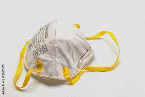 Old and dirty N95 face mask isolate on white background.Close up disposable face mask.