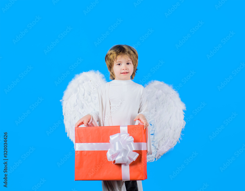 Valentine day. February 14. Little cupid boy. Kid angel with present. Little angel with white wings holds present. Child cupid with white angel wings. Happy Valentine Day. Cupid. Amour. Valentine. Valentine day. February 14. Little cupid boy. Kid angel with present. Little angel with white wings holds present. Child cupid with white angel wings. Happy Valentine Day. Cupid. Amour. Valentine.