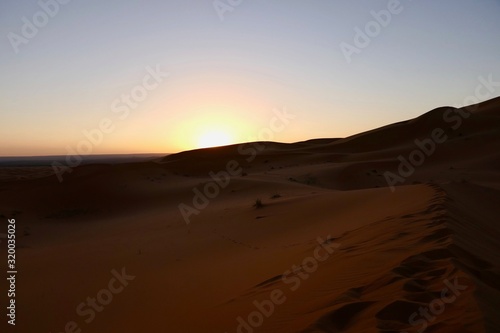 Sand dunes in Sahara with interesting shades and texture in desert landscape during sunrise, Morocco, Africa