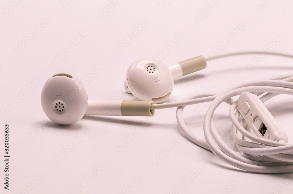 Closeup white Earphones isolate on white background. Closeup white Earphones isolate on white background.