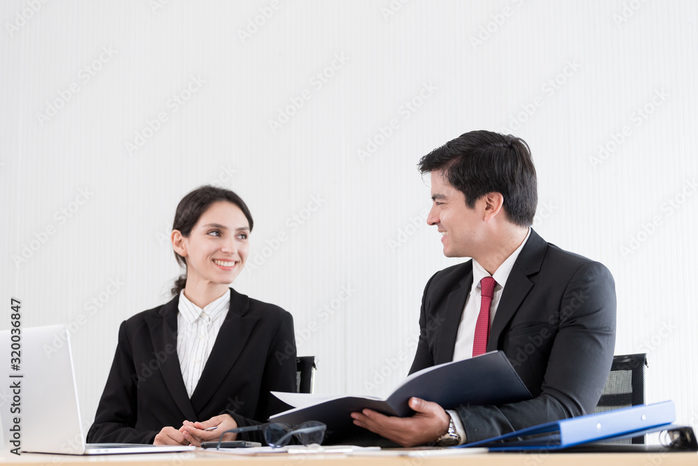 A manager and secretary working together in the office. A manager and secretary working together in the office.