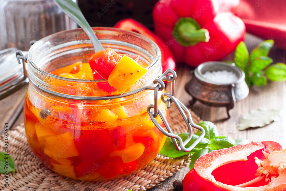 Fermented multicolored bell peppers in a glass jar, selective focus Fermented multicolored bell peppers in a glass jar, selective focus