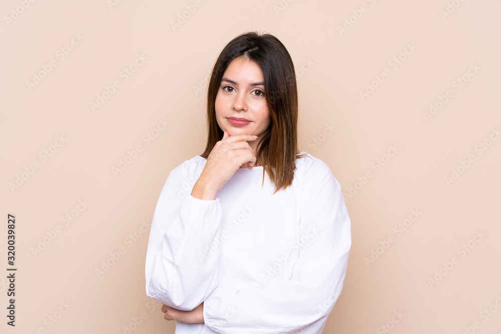 Young woman over isolated background thinking an idea Young woman over isolated background thinking an idea