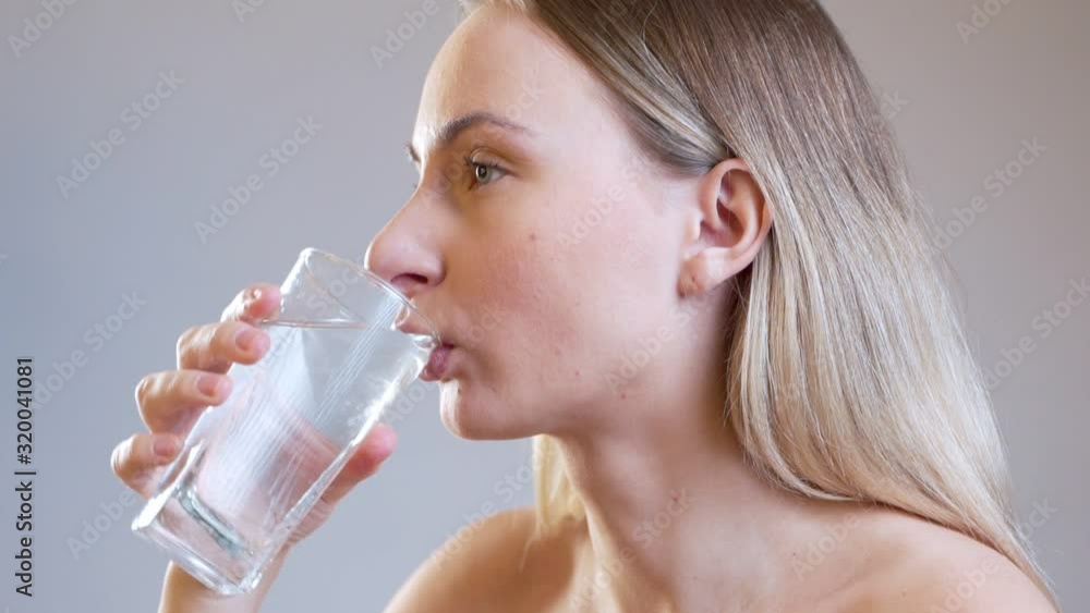 Young woman takes pill and drinks glass of clean water. girl is holding medicine and glass of water. Young woman takes pill and drinks glass of clean water. girl is holding medicine and glass of water.