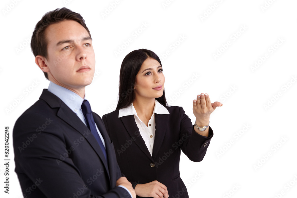 A young business woman is showing a hand gesture while a young business man looks ahead. He is unconvinced. A young business woman is showing a hand gesture while a young business man looks ahead. He is unconvinced.