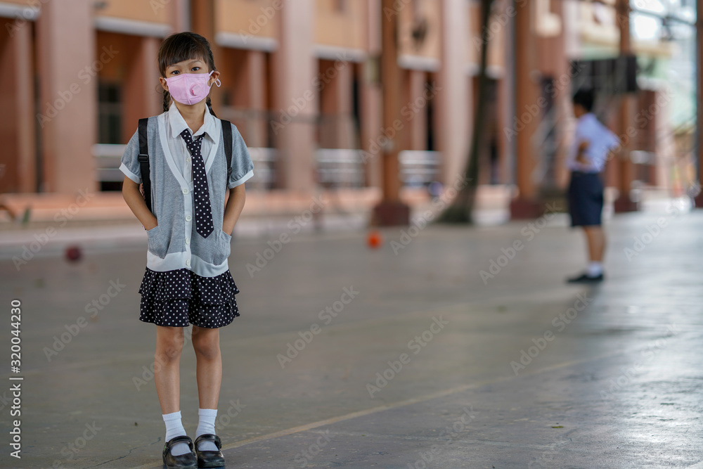 Asian girl in kindergarten school wearing n95 mask for prevent PM2.5/ flu/corona virus/ germs