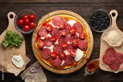 Stages of making pizza. Salami pizza