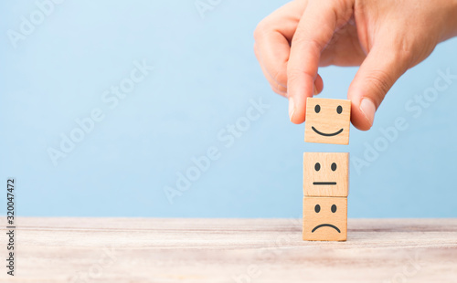customer satisfaction concept. smiling face on sad face
