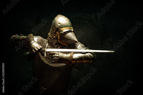 Canvas Print Portrait of a knight in armor, his sword in his hands, performing an attack para