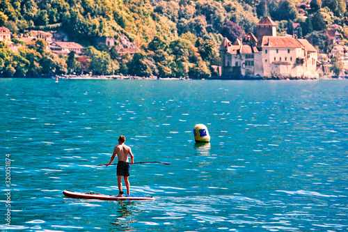 Montreux, Switzerland - August 28, 2016: Man standing on Standup paddle surfing on Geneva Lake in Montreux, Vaud canton, Switzerland