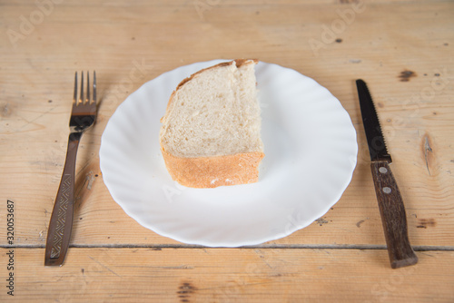 A slice of bread on a plate with a fork and knife