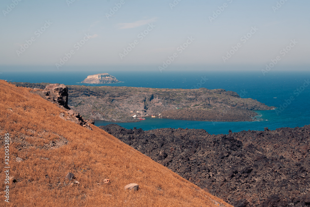 View on the Nea Kameni volcano island near Santorini island at sunny weather at Greece