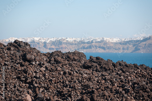 View on the Nea Kameni volcano island near Santorini island at sunny weather at Greece