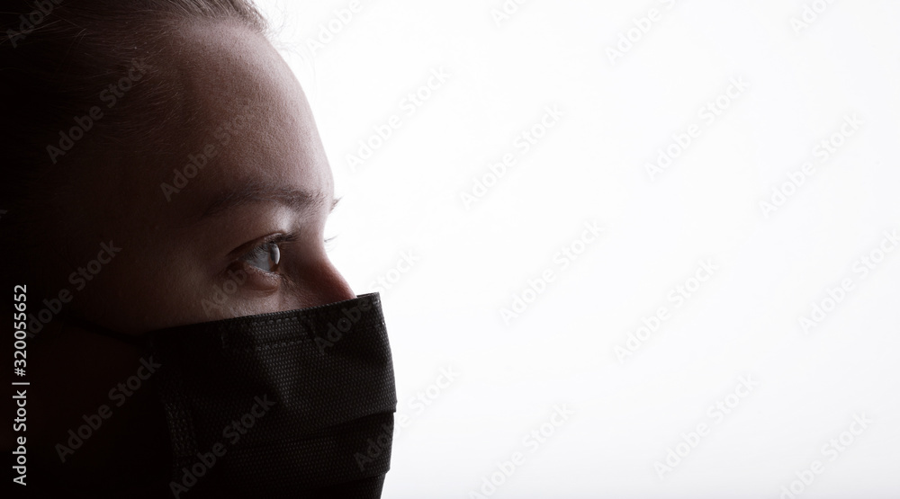 Closeup portrait of young woman in protective respirator. Female wearing medical mask. Free space for text. White background. Healthcare, personal protection, virus, air pollution concept. Closeup portrait of young woman in protective respirator. Female wearing medical mask. Free space for text. White background. Healthcare, personal protection, virus, air pollution concept.