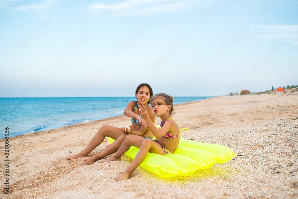 Fototapeta premium Sisters tell something and show each other.