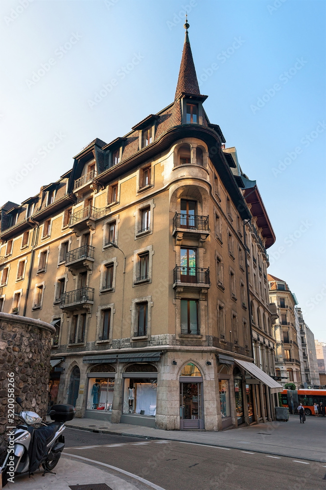 Building architecture on Rue du Purgatoire Street, Geneva city center, Switzerland. People on the background