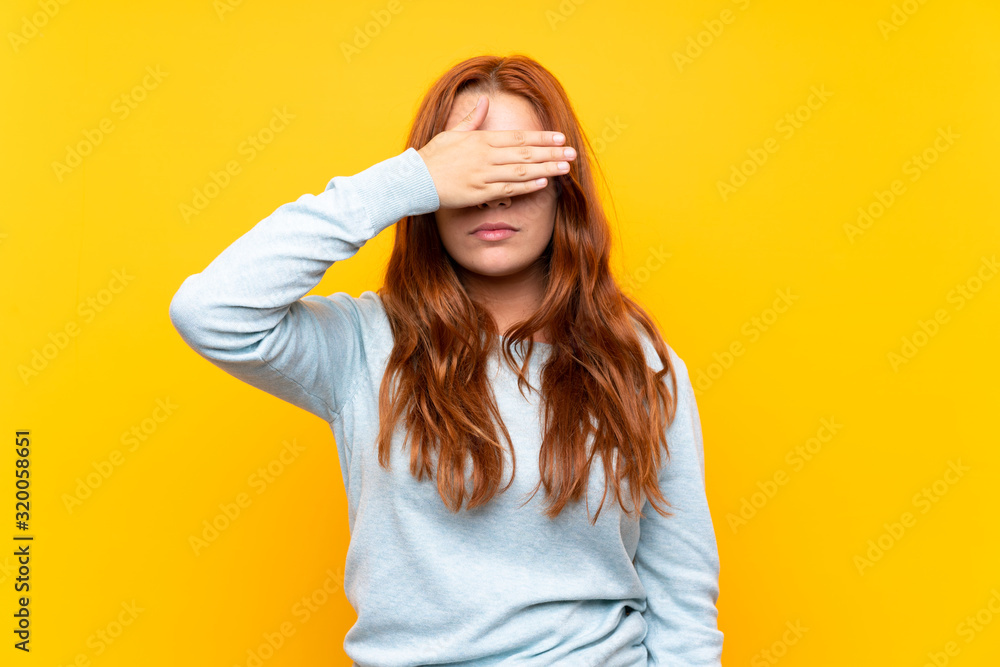 Teenager redhead girl over isolated yellow background covering eyes by hands. Do not want to see something