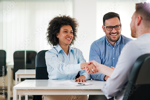 Smiling HR managers handshake with a job candidate. photo
