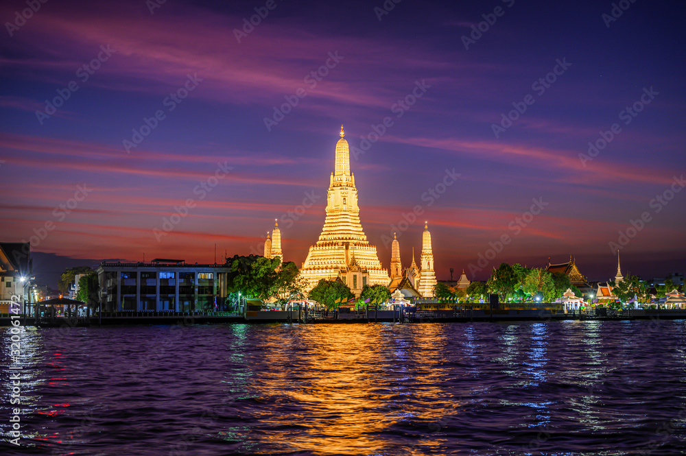 Lighten up pagoda of Wat Arun Temple (The Temple of Dawn) at dusk with twilight sky (Bangkok, Thailand)