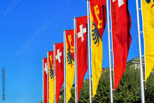 Swiss flags and Geneva canton flags on promenade of Lake Geneva of Switzerland
