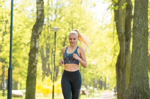 Attractive woman in sportswear training outdoor. Sport, jogging, healthy and active lifestyle.