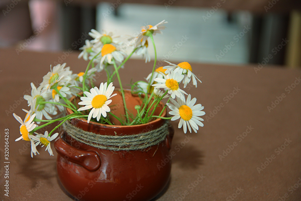 bouquet of flowers in a vase on wooden table