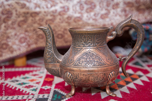Εκτύπωση καμβά vintage oriental teapot on a background of carpet