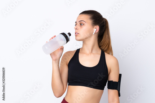 Teenager sport girl over isolated white background with sports water bottle