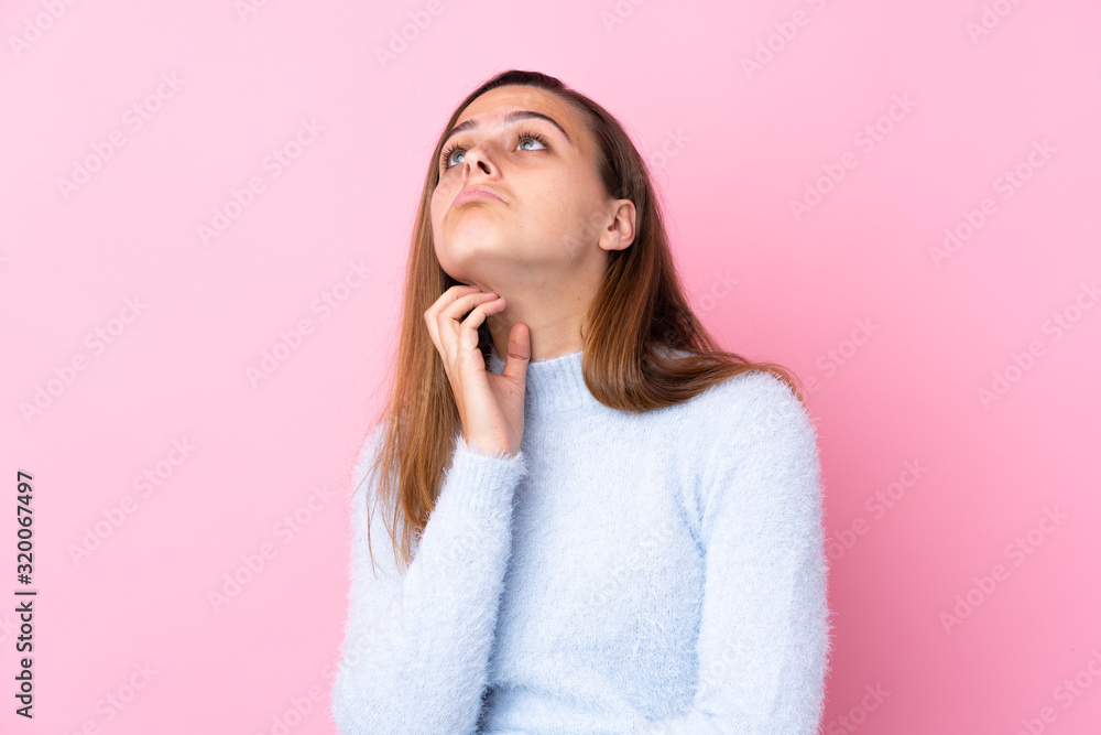 Teenager girl with blue sweater over isolated pink background thinking an idea Teenager girl with blue sweater over isolated pink background thinking an idea