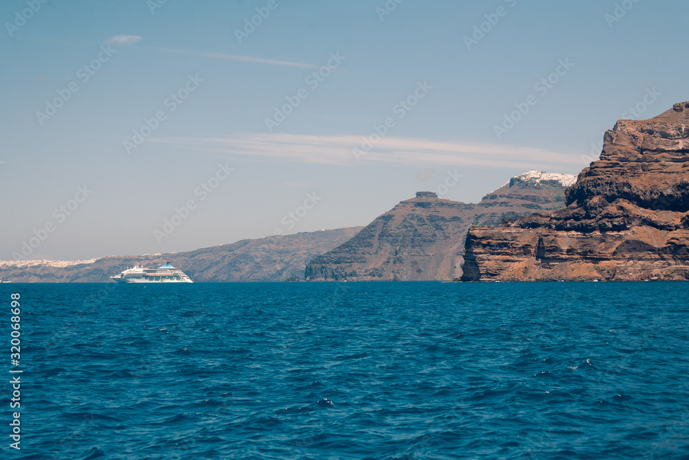 View on the Santroini island harbor and cliffs at sun weather