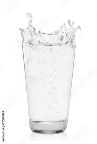 Glass of water with splash on a white background. Isolated
