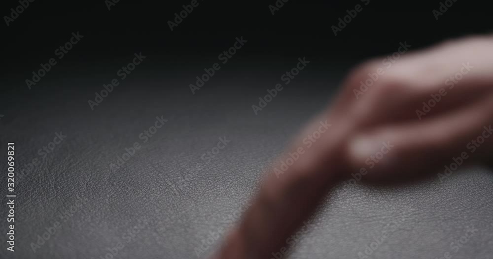 Slow motion man hand touching soft leather cushion Slow motion man hand touching soft leather cushion