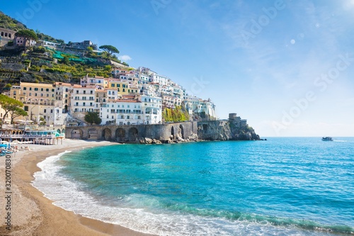 Fototapeta Naklejka Na Ścianę i Meble -  Beautiful Amalfi with hotels on hills leading down to coast, comfortable beaches and azure sea in Campania, Italy.