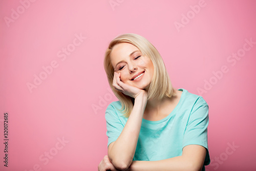 Beautiful smiling woman on pink background
