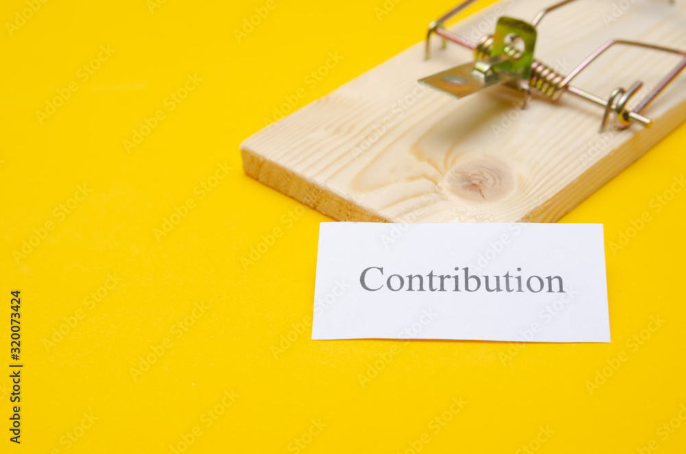 mousetrap with a piece of paper and the inscription Contribution on a yellow background with copy space. The concept of debt, according to mousetrap with a piece of paper and the inscription Contribution on a yellow background with copy space. The concept of debt, according to