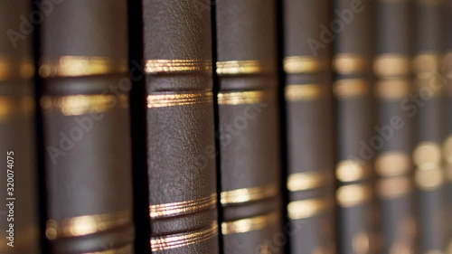 Books on the table in library, shallow depth of field. Books with a luxurious leather binding. 4k