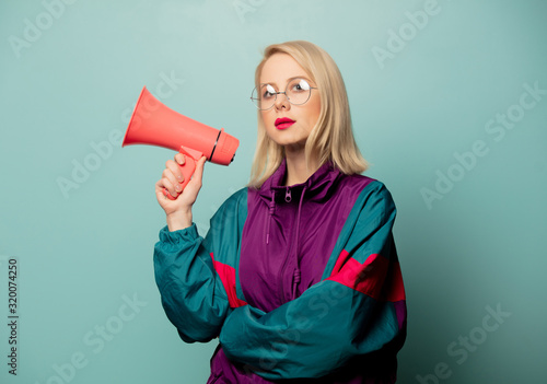 Style blonde woman in glasses with loudspeaker
