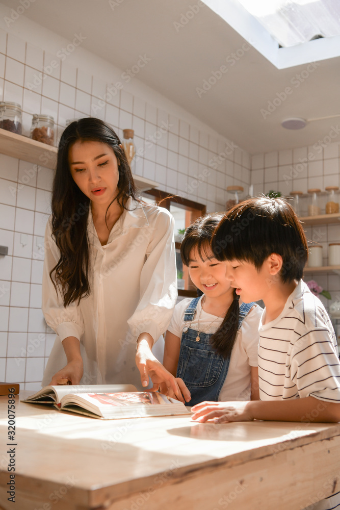 Family happy moments when children Helping mom cook food in the kitchen. Family happy moments when children Helping mom cook food in the kitchen.