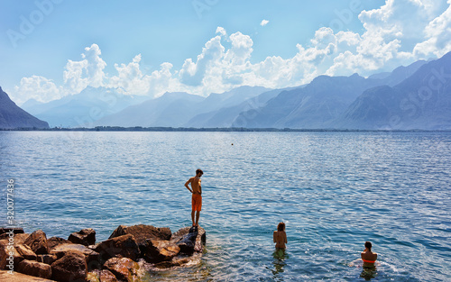 People swimming in Geneva Lake in Montreux, Vaud canton, Switzerland © Roman Babakin